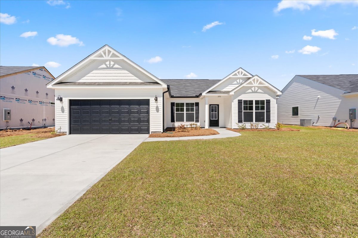 292 Timberlake Drive Guyton, GA 31312 - Photo 1 of 1 a front view of a house with a garden