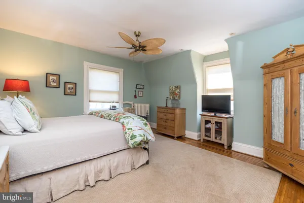 a bedroom with furniture and a wooden floor