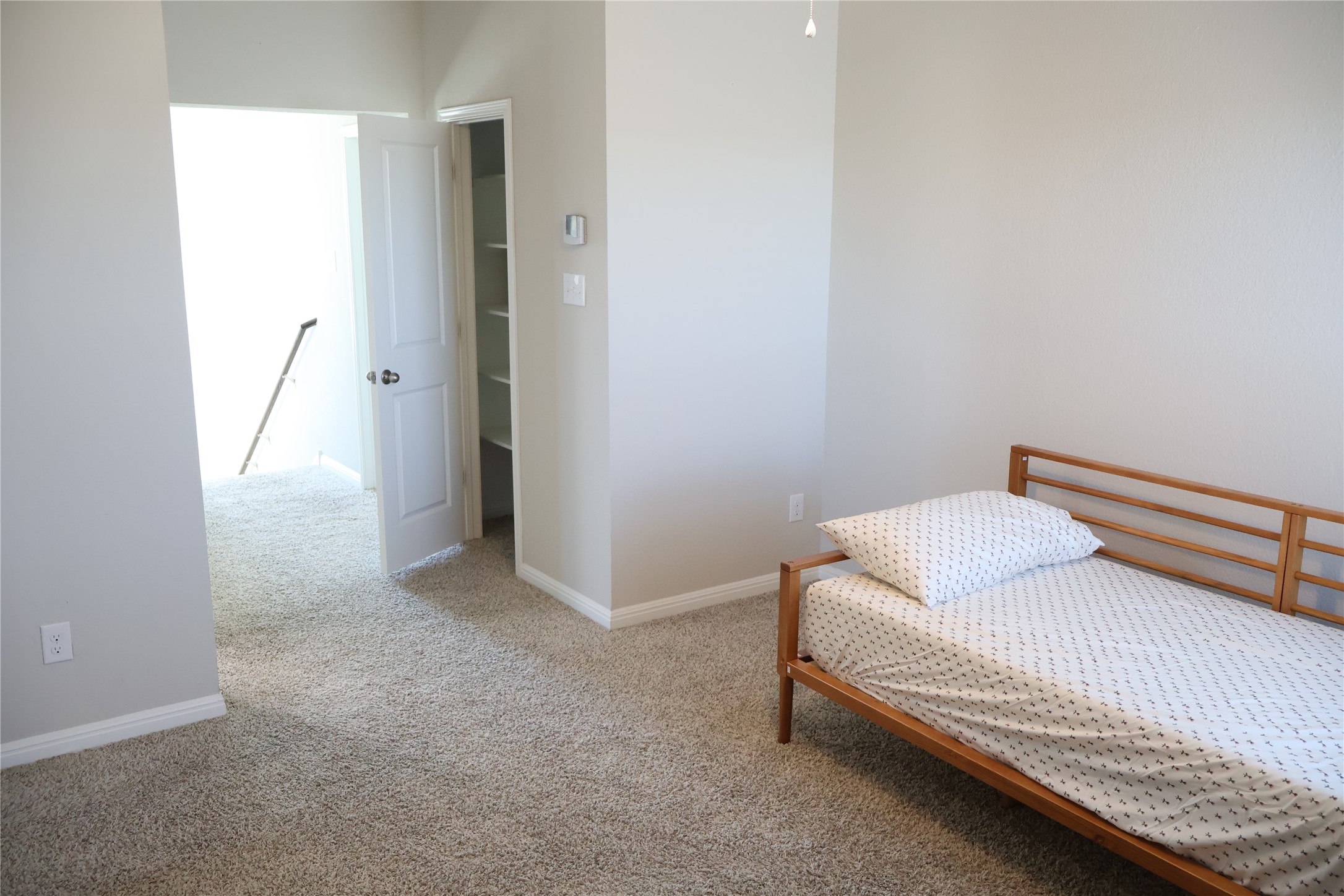 11500 Maple Leaf Way Manor, TX 78653 - Photo 27 of 29 Bedroom with light carpet and baseboards