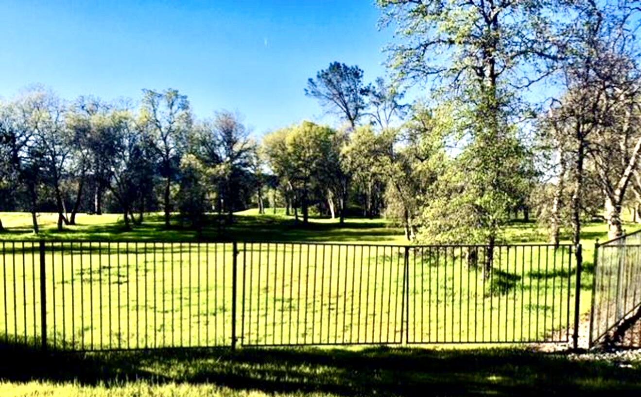 13212 Tierra Heights Road Redding, CA 96003 - Photo 2 of 4 a view of a house with a wooden fence