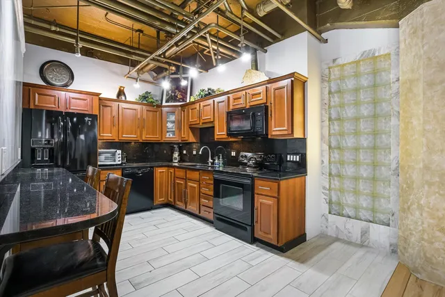 a kitchen with stainless steel appliances granite countertop a stove and a sink