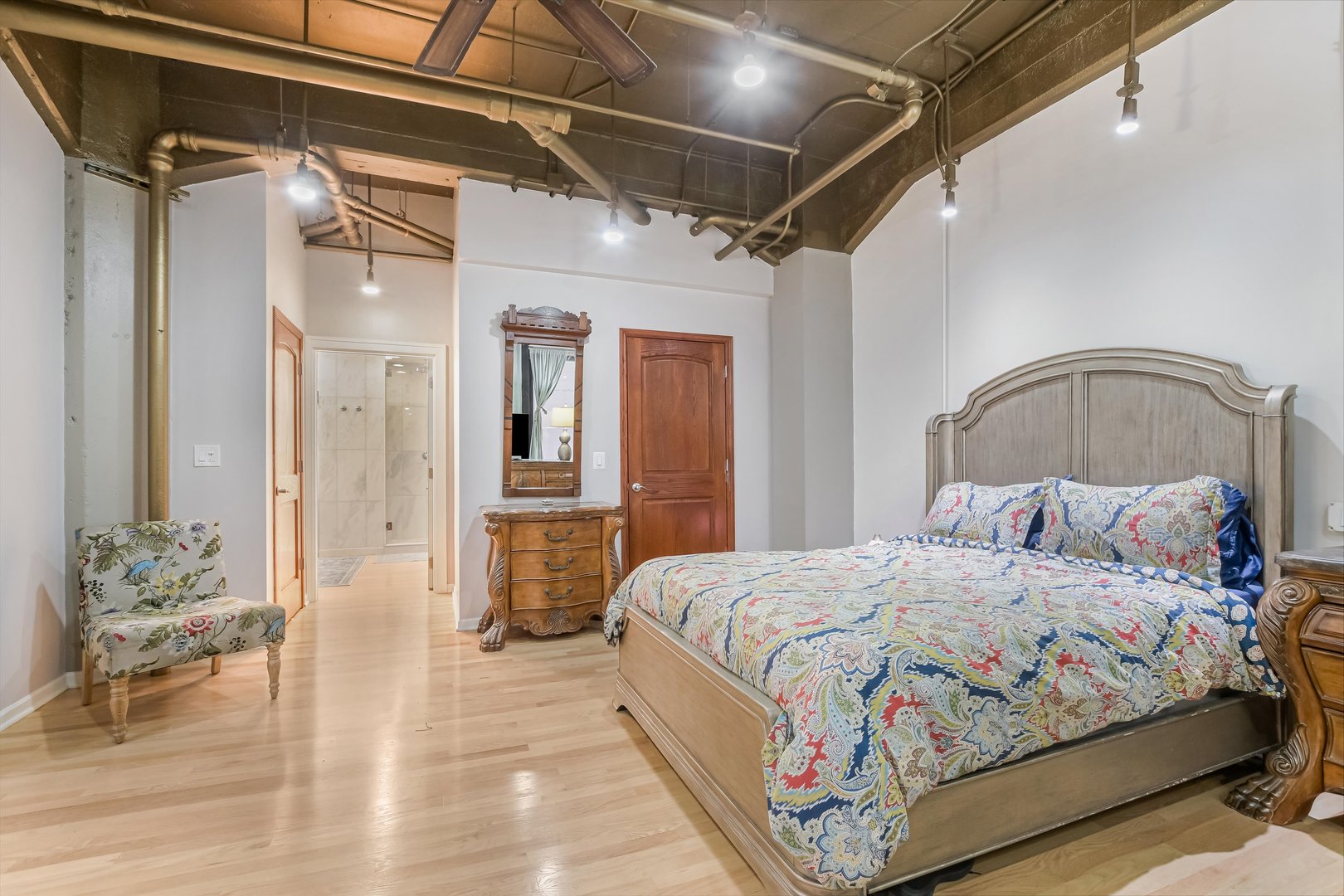 124 West Polk Street, Unit 100 Chicago, IL 60605 - Photo 16 of 45 a bedroom with a bed and a mirror