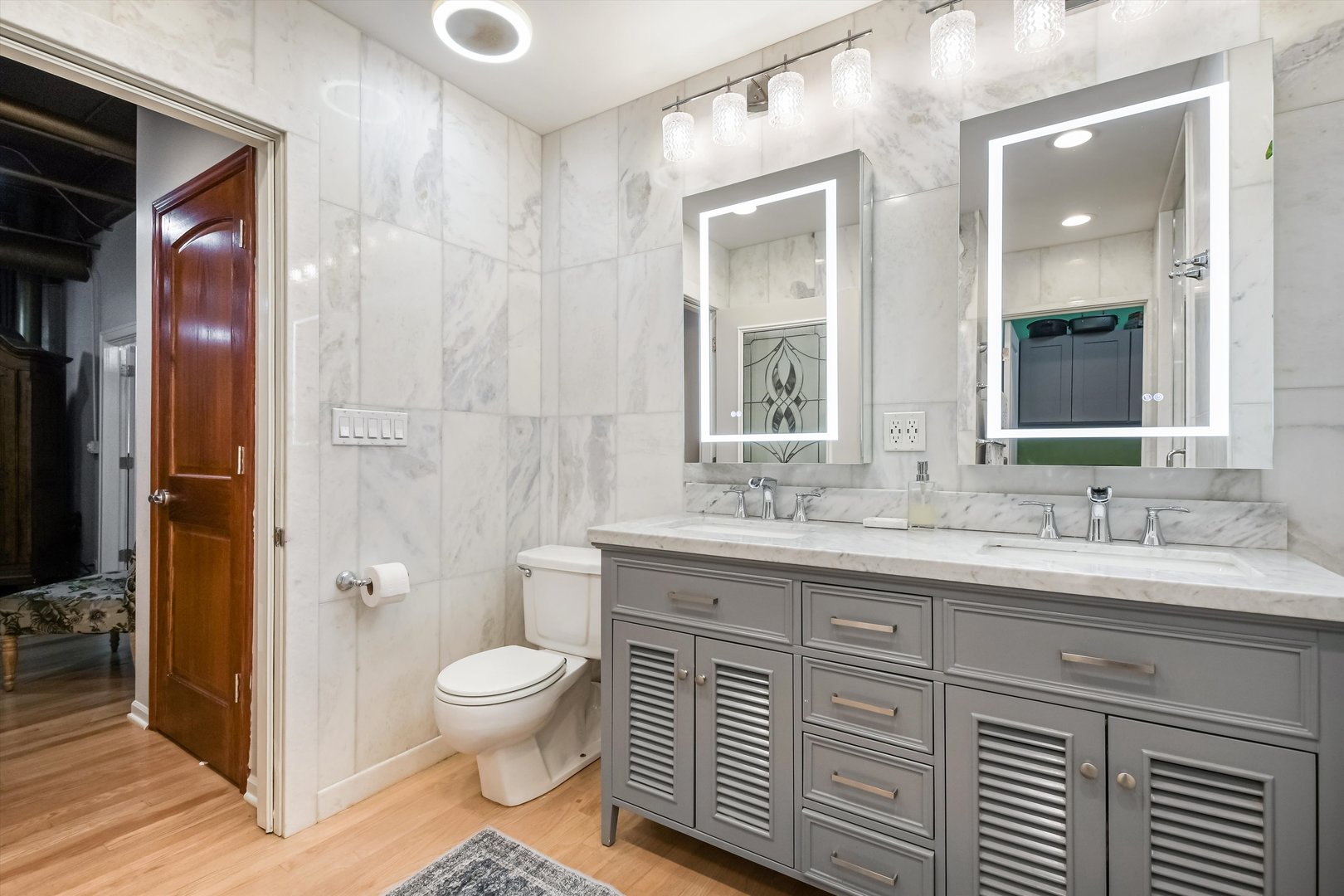 124 West Polk Street, Unit 100 Chicago, IL 60605 - Photo 20 of 45 a spacious bathroom with a granite countertop sink a toilet and a shower