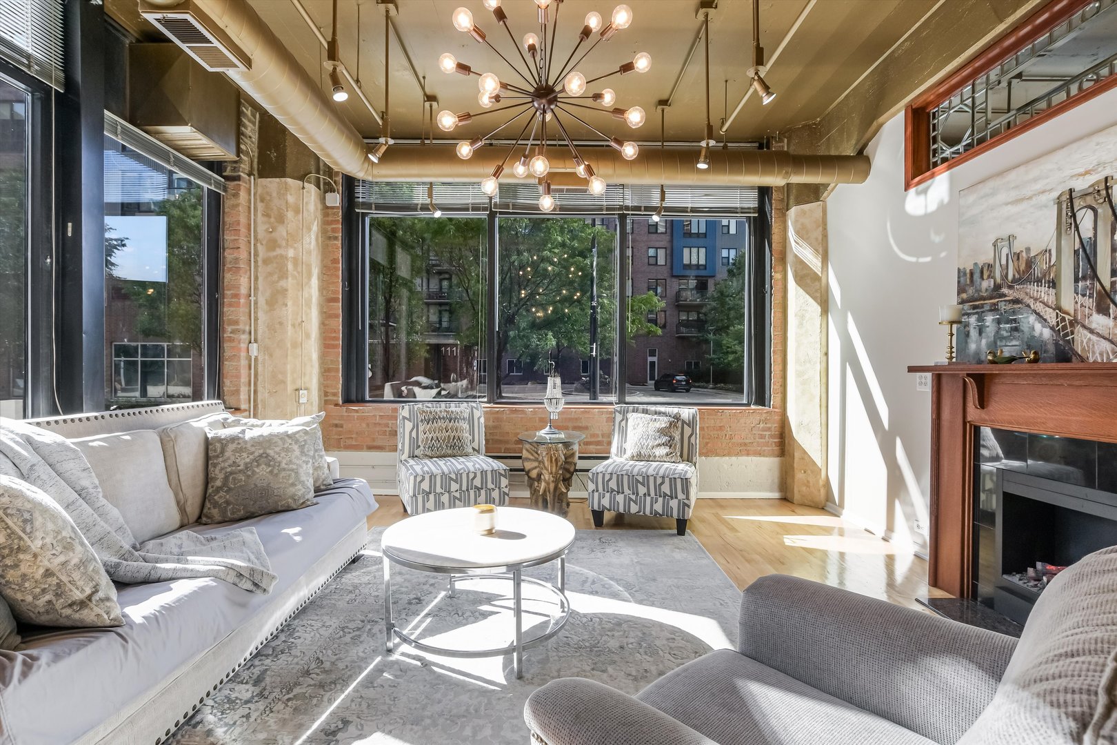 124 West Polk Street, Unit 100 Chicago, IL 60605 - Photo 2 of 45 a living room with fireplace furniture and a large window