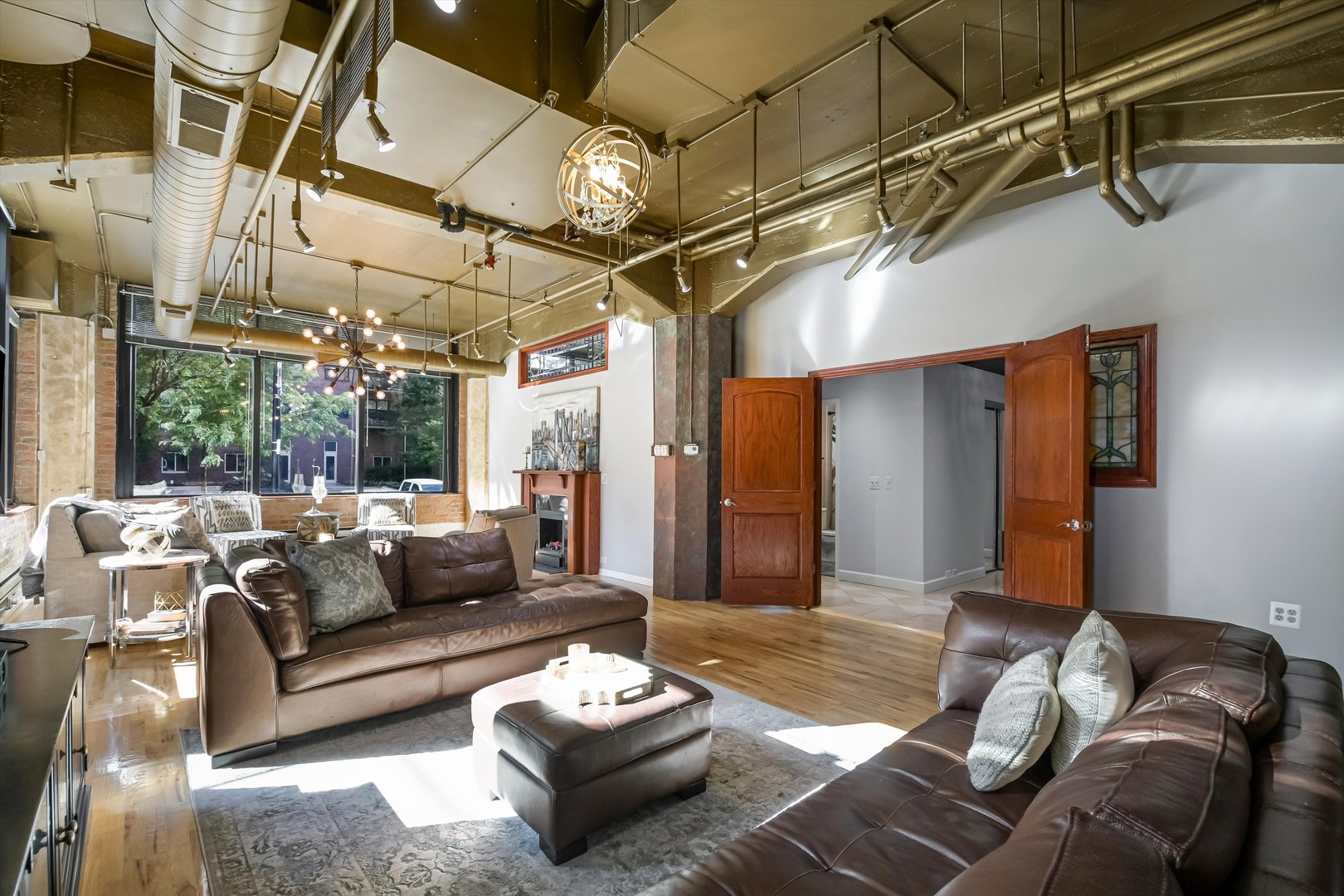124 West Polk Street, Unit 100 Chicago, IL 60605 - Photo 3 of 45 a living room with furniture and a chandelier