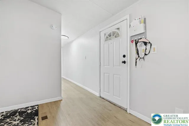 a view of bedroom with furniture and flat screen tv