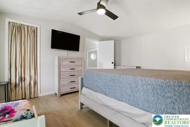 a bathroom with a granite countertop toilet sink and mirror