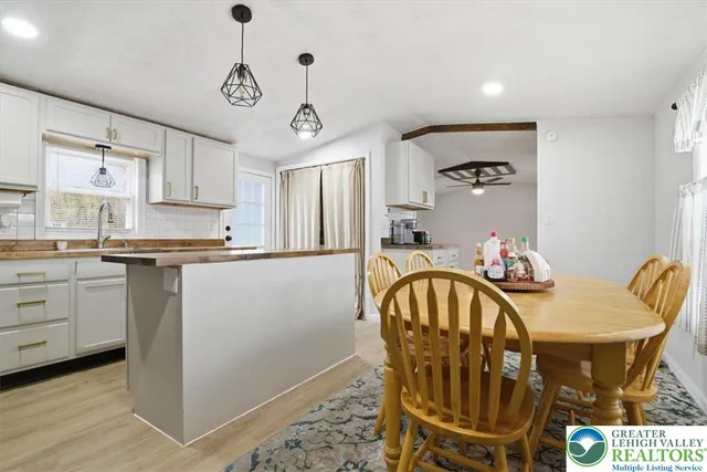 a kitchen with stainless steel appliances granite countertop a sink a stove and cabinets