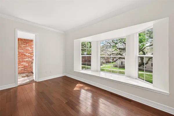 wooden floor with white cabinets