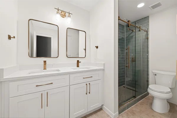a white toilet sitting next to a bathroom sink