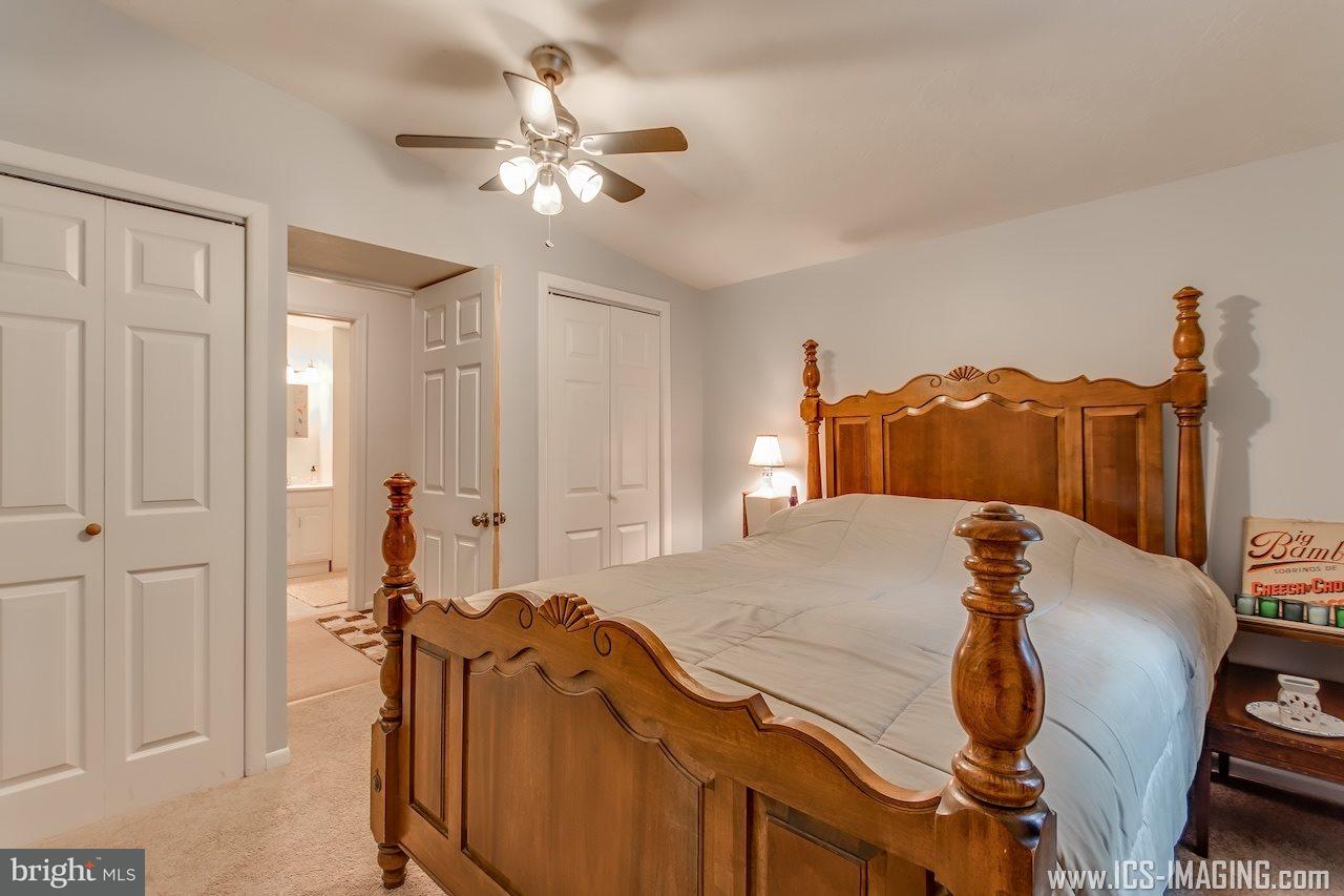 2105 Copenhaffer Road Dover, PA 17315 - Photo 12 of 36 a bedroom with a bed and a chandelier