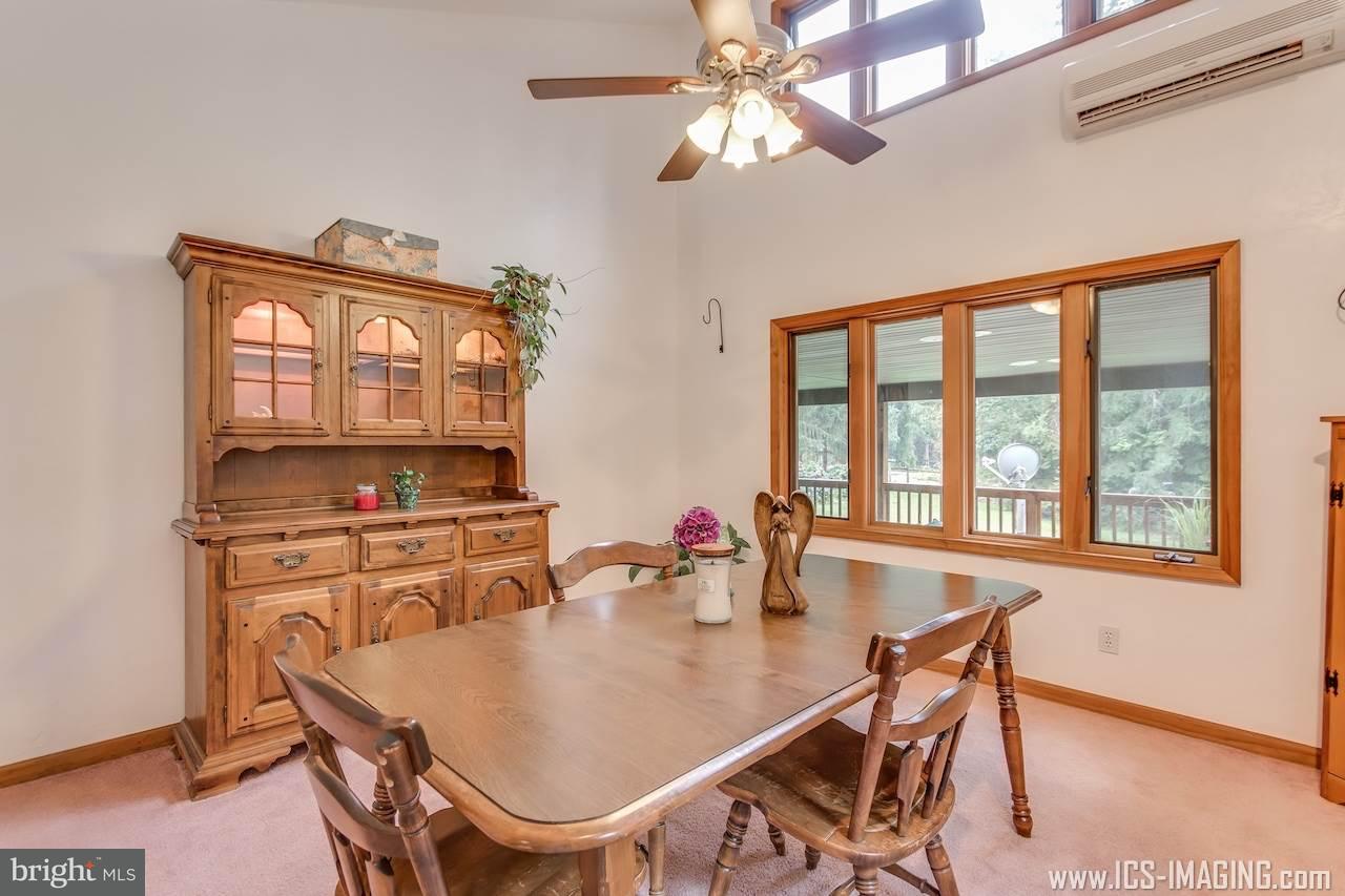 2105 Copenhaffer Road Dover, PA 17315 - Photo 15 of 36 a dining room with furniture a chandelier and wooden floor
