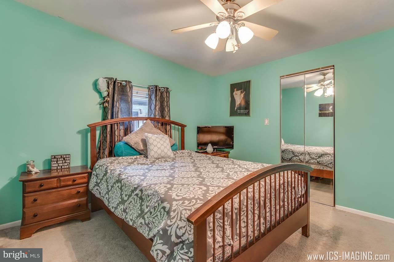 2105 Copenhaffer Road Dover, PA 17315 - Photo 16 of 36 a bedroom with a bed and a chandelier
