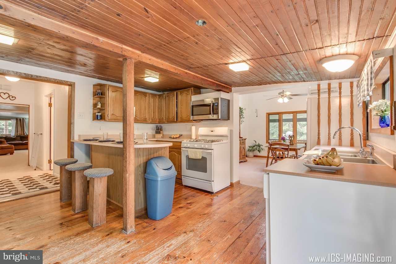 2105 Copenhaffer Road Dover, PA 17315 - Photo 17 of 36 a kitchen with furniture a counter top space stainless steel appliances and wooden floor