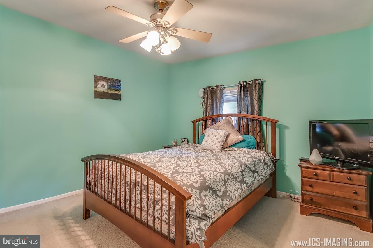 2105 Copenhaffer Road Dover, PA 17315 - Photo 18 of 36 a bedroom with a bed and wooden floor