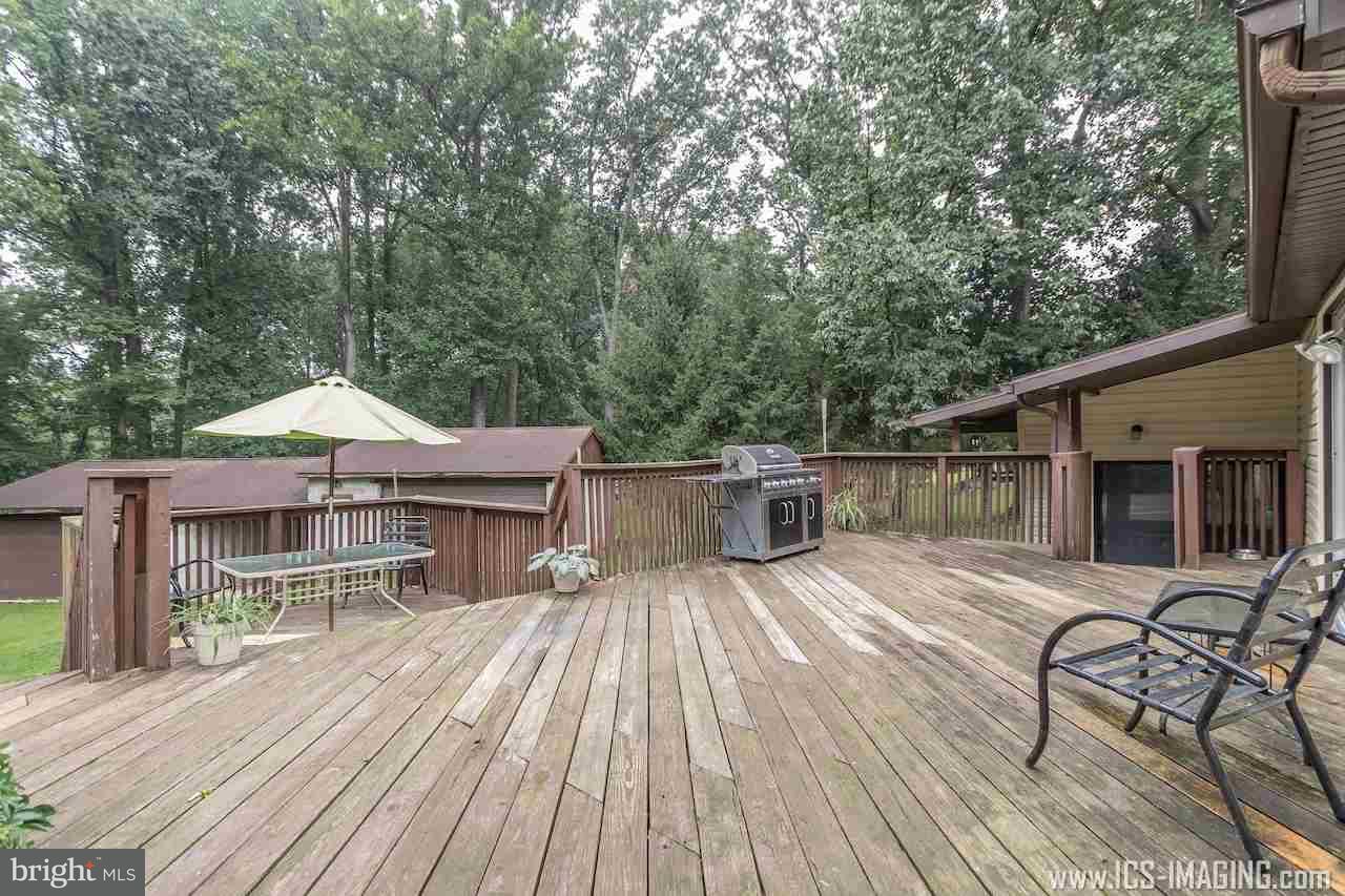 2105 Copenhaffer Road Dover, PA 17315 - Photo 32 of 36 a patio of a house with wooden floor yard barbeque oven and outdoor seating