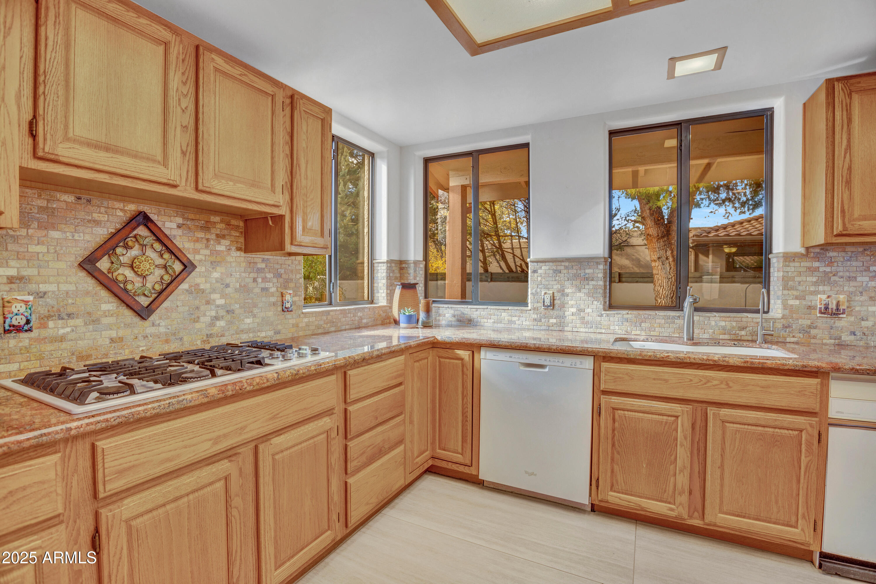 375 Indian Cliffs Road Sedona, AZ 86336 - Photo 11 of 28 a kitchen with granite countertop stainless steel appliances a sink stove and cabinets