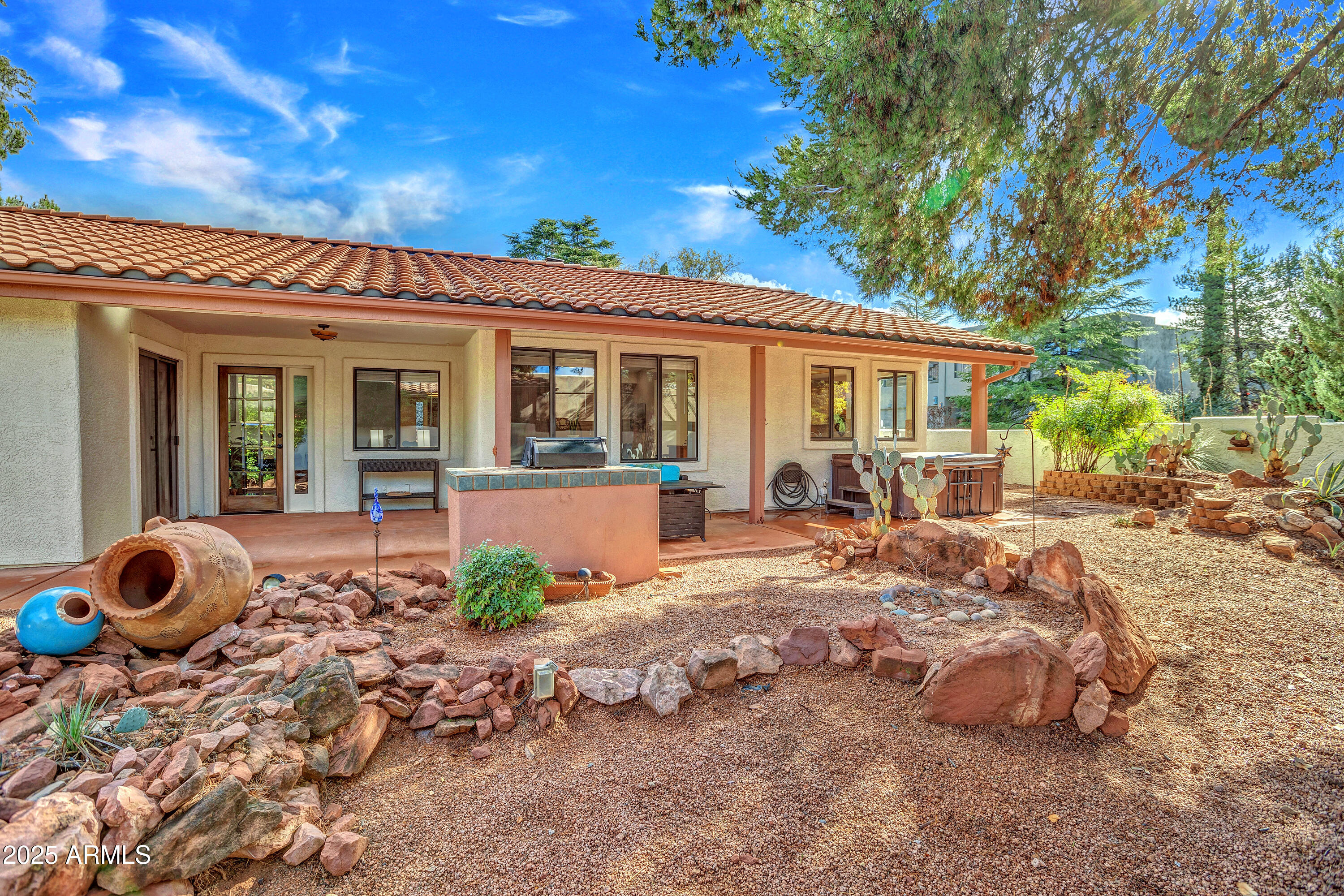 375 Indian Cliffs Road Sedona, AZ 86336 - Photo 2 of 28 a front view of a house with garden