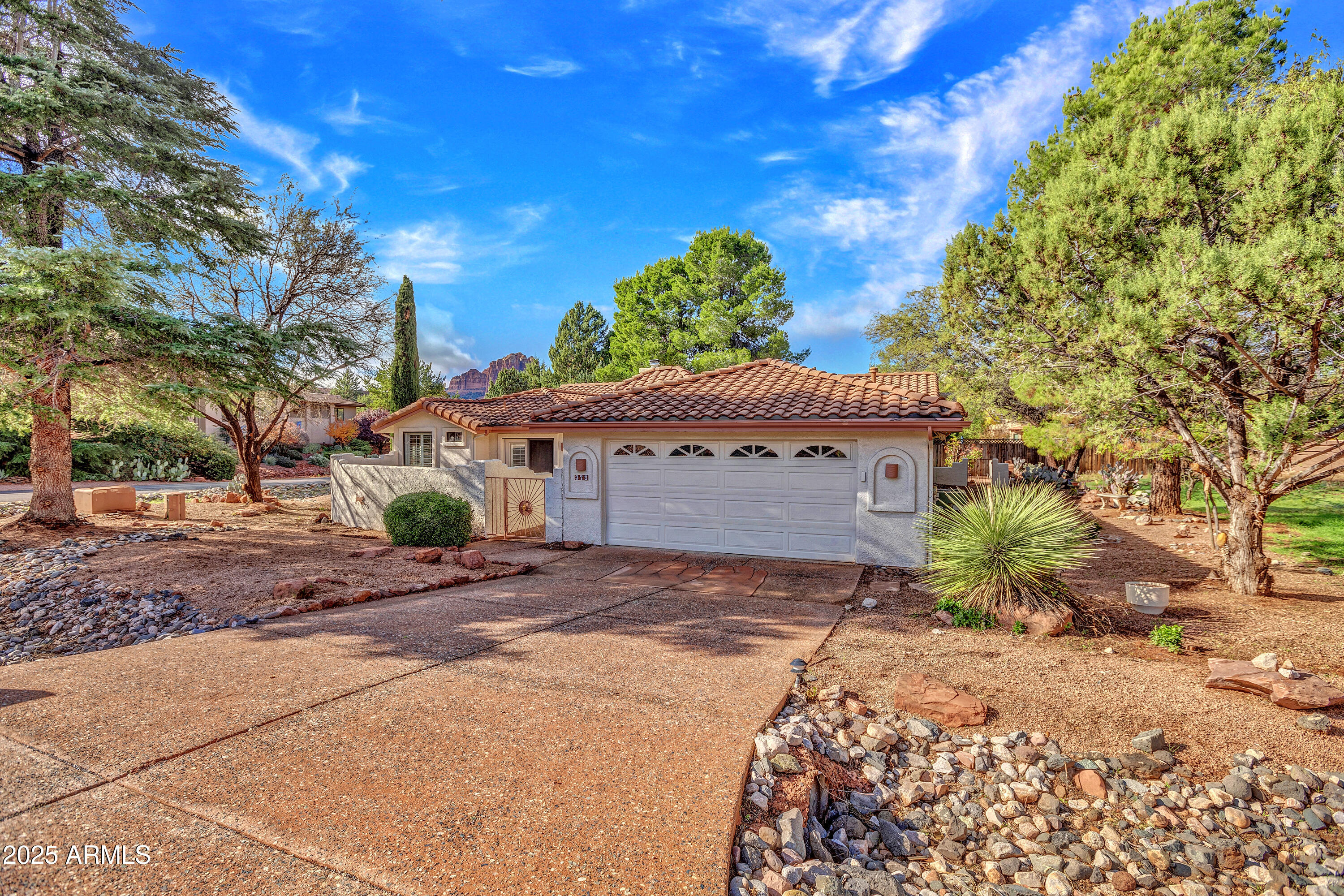 375 Indian Cliffs Road Sedona, AZ 86336 - Photo 26 of 28 a front view of a house with a yard