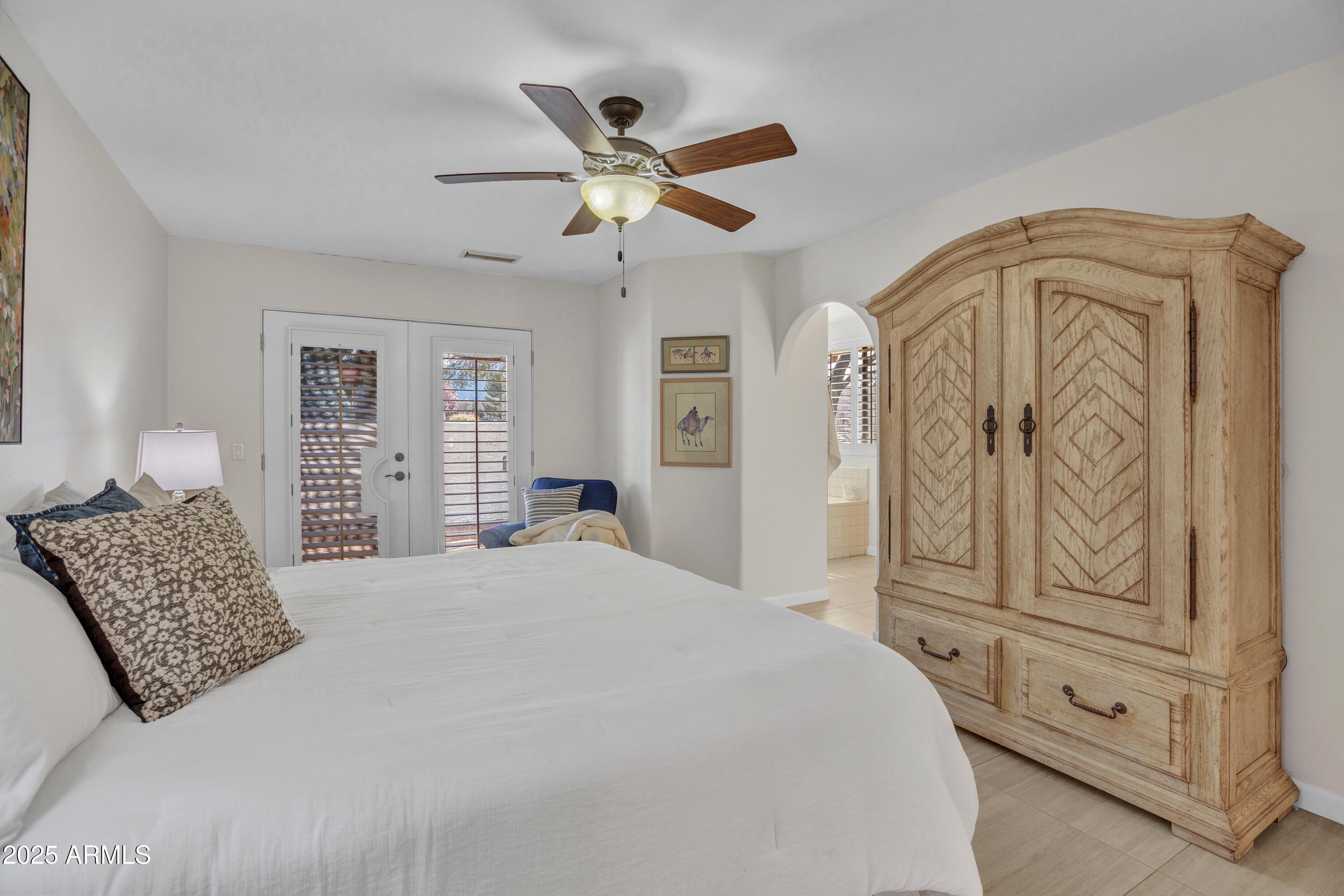 375 Indian Cliffs Road Sedona, AZ 86336 - Photo 5 of 28 a bedroom with a large bed and ceiling fan