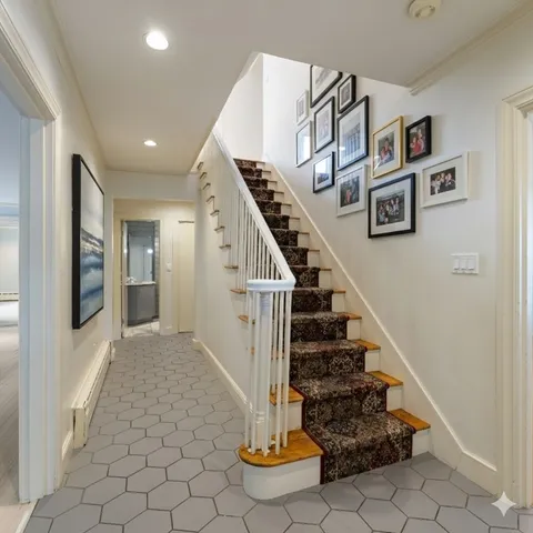 a view of a room with wooden floor and brick walls