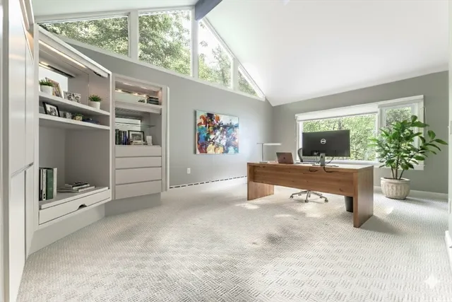a kitchen with white cabinets and refrigerator