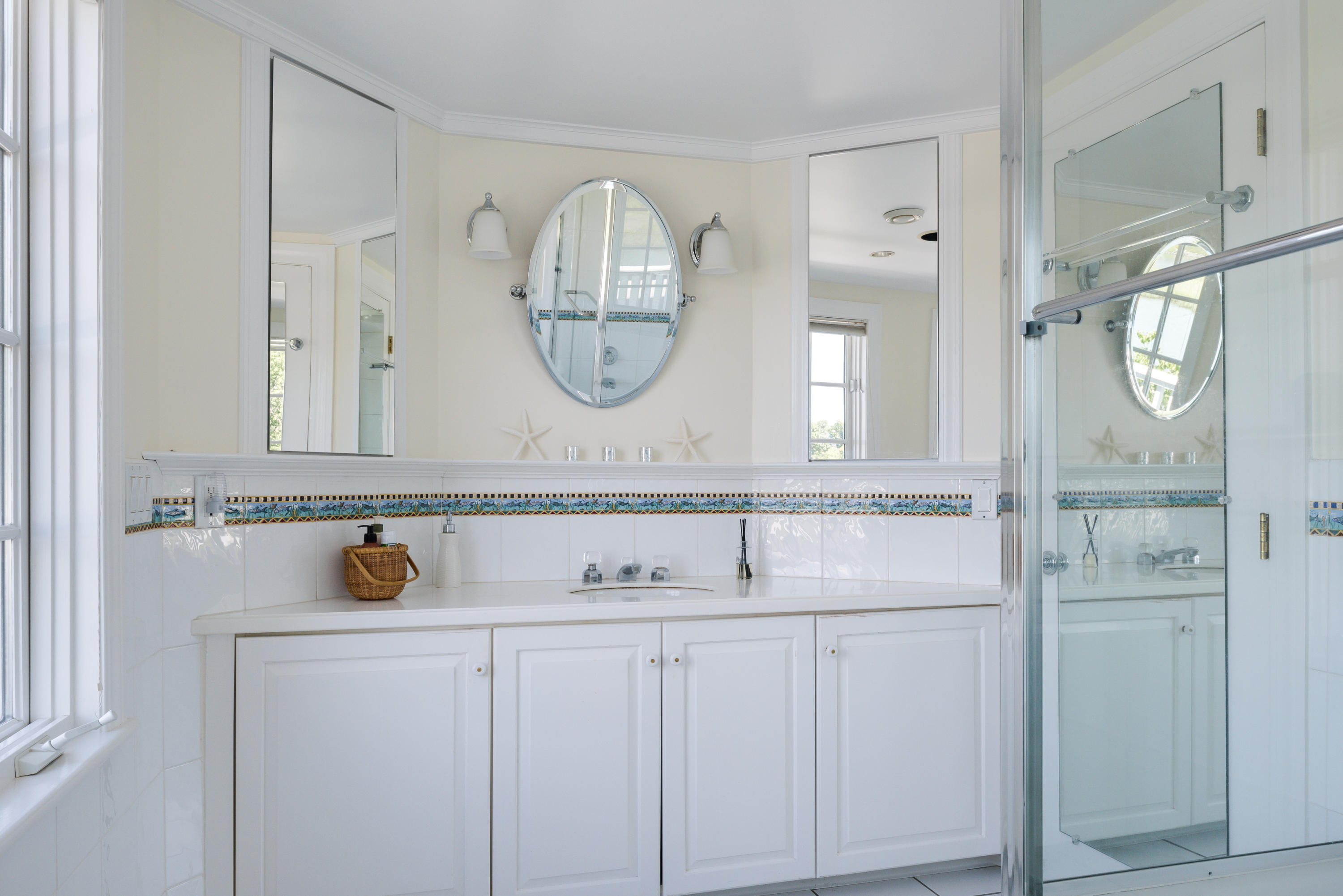 18 Pine Point Road Rowayton, CT 06853 - Photo 13 of 37 a bathroom with a sink a mirror a vanity and a shower