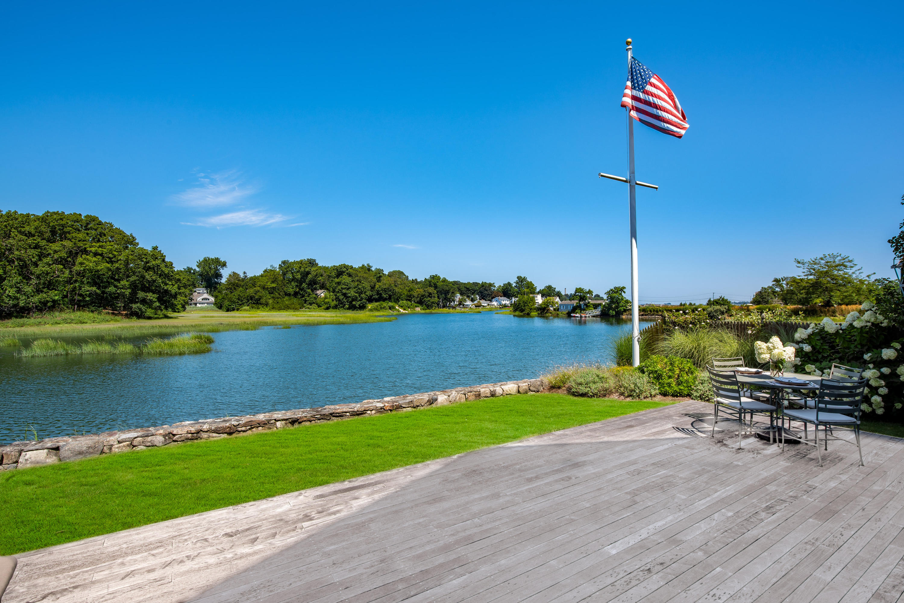 18 Pine Point Road Rowayton, CT 06853 - Photo 17 of 37 a view of a lake with a table and chairs
