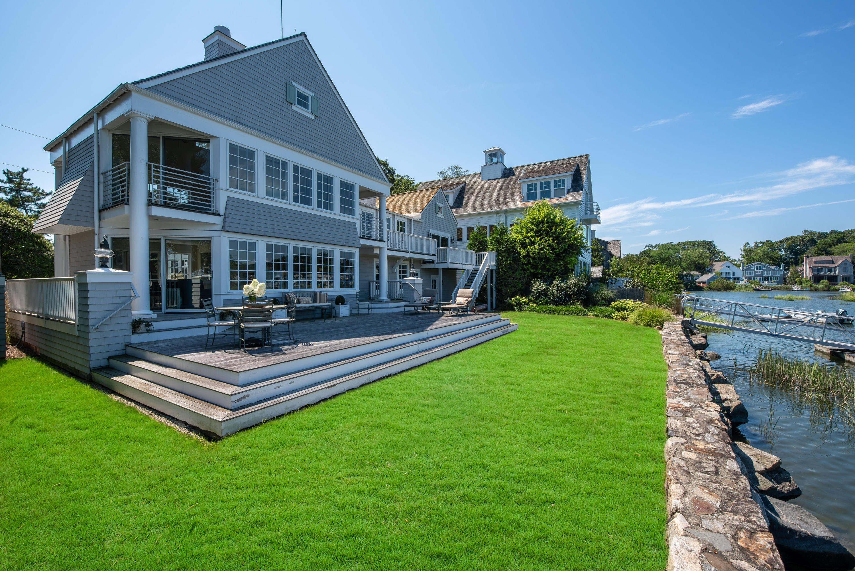 18 Pine Point Road Rowayton, CT 06853 - Photo 20 of 37 a view of a house with a yard table and chairs