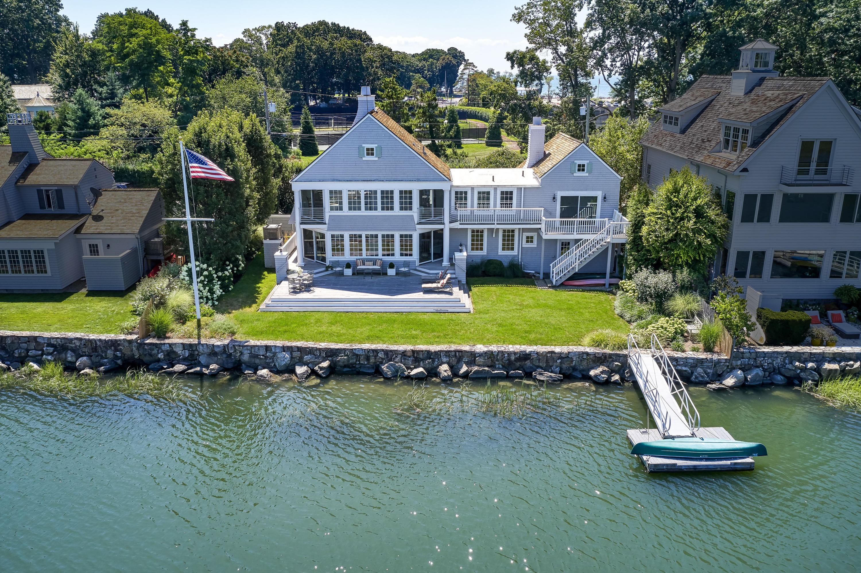 18 Pine Point Road Rowayton, CT 06853 - Photo 2 of 37 a aerial view of a house with swimming pool a yard and lake view
