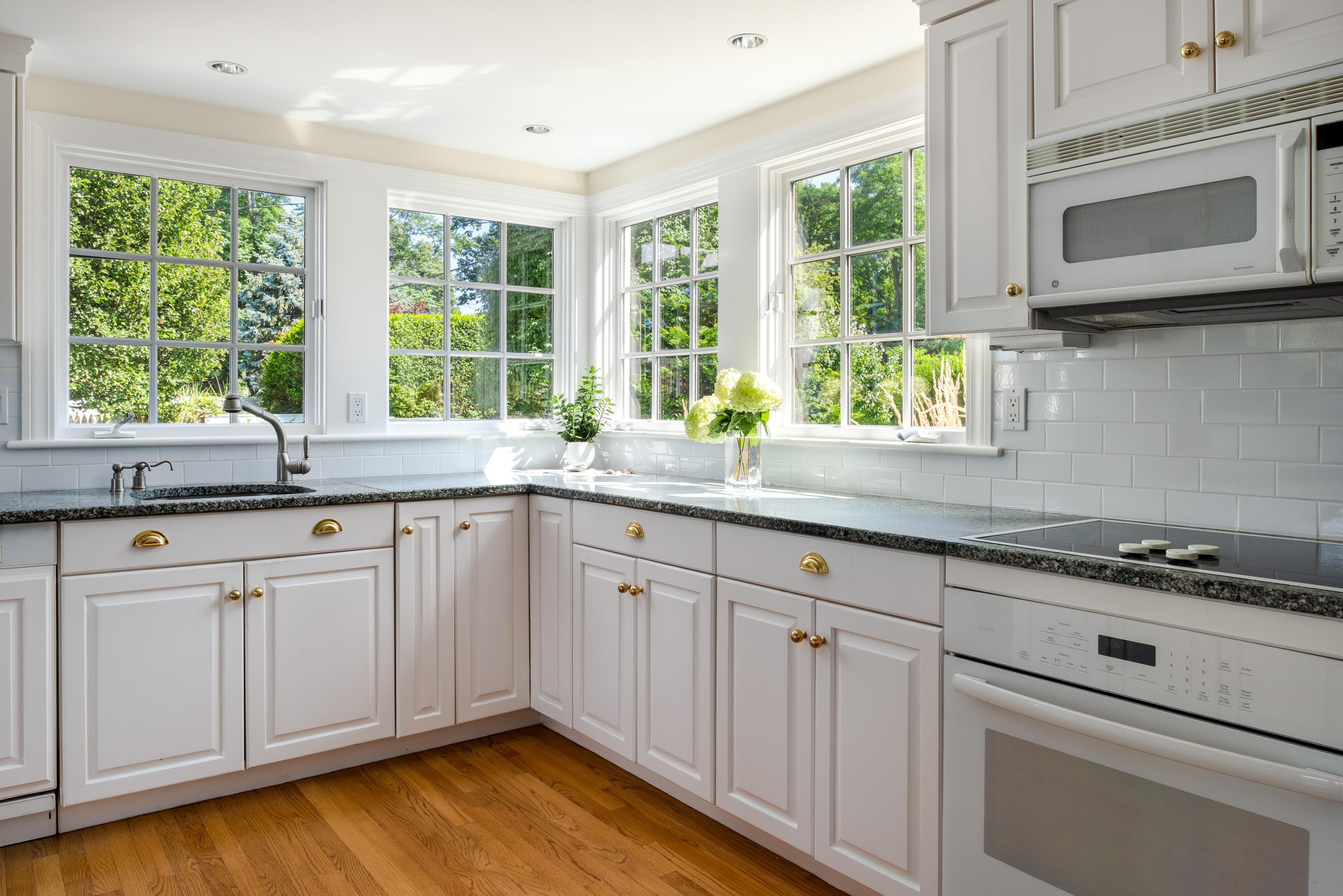 18 Pine Point Road Rowayton, CT 06853 - Photo 9 of 37 a kitchen with stainless steel appliances granite countertop white cabinets a window and a sink