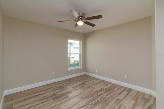 wooden floor in an empty room with a window