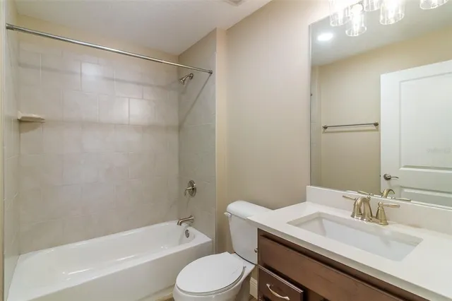 a bathroom with a sink toilet vanity and shower