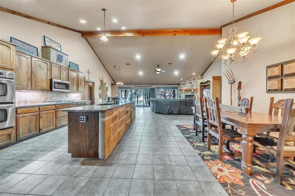 139 Pr-1537 Road Bridgeport, TX 76426 - Photo 26 of 40 a kitchen with stainless steel appliances kitchen island granite countertop a large counter top a stove a chimney a sink and cabinets