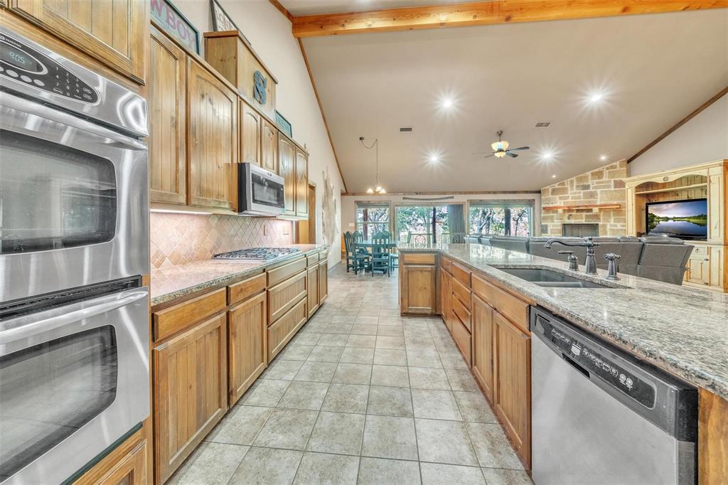 139 Pr-1537 Road Bridgeport, TX 76426 - Photo 27 of 40 a large kitchen with stainless steel appliances kitchen island granite countertop a large counter top and a stove