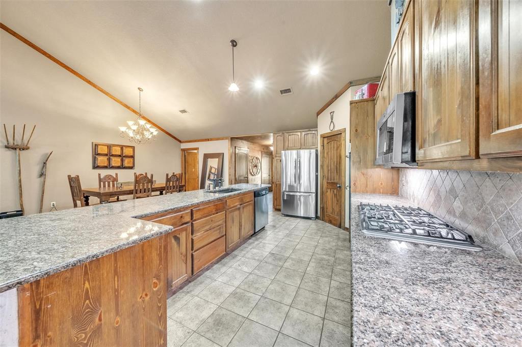 139 Pr-1537 Road Bridgeport, TX 76426 - Photo 29 of 40 a large kitchen with stainless steel appliances granite countertop a granite counter tops and a view of living room