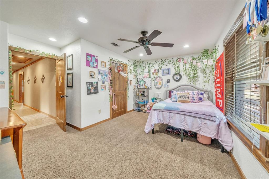 139 Pr-1537 Road Bridgeport, TX 76426 - Photo 37 of 40 a spacious bedroom with a bed and a chandelier