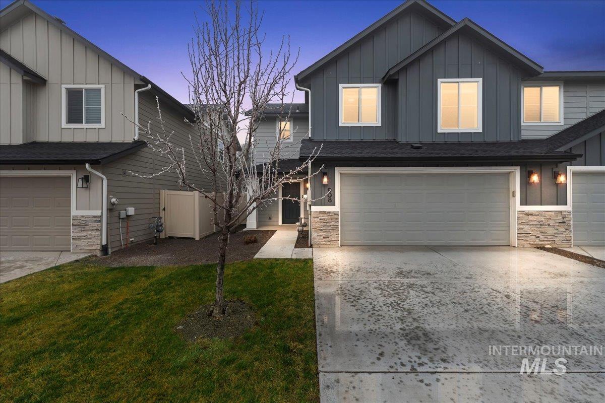 908 West Woodpine Street Meridian, ID 83646 - Photo 1 of 1 Craftsman-style house featuring board and batten siding, stone siding, and a garage