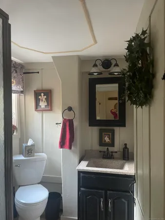 a bathroom with a toilet sink and mirror