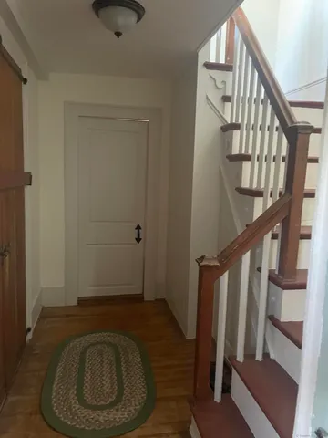 a view of entryway with wooden floor and stairs