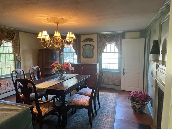 a view of a dining room with furniture and chandelier