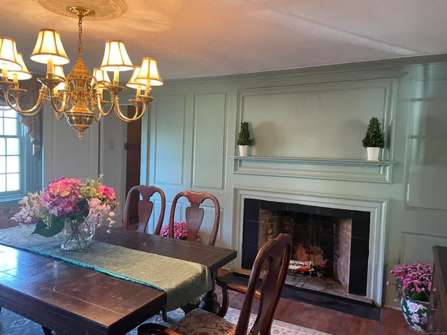 a view of a dining room with furniture and chandelier