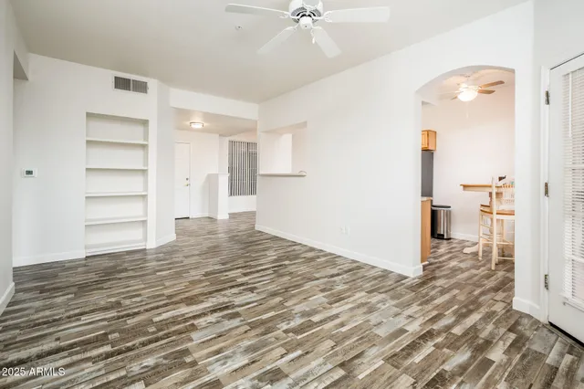a view of a bedroom with wooden floor & cabinet and a bathroom