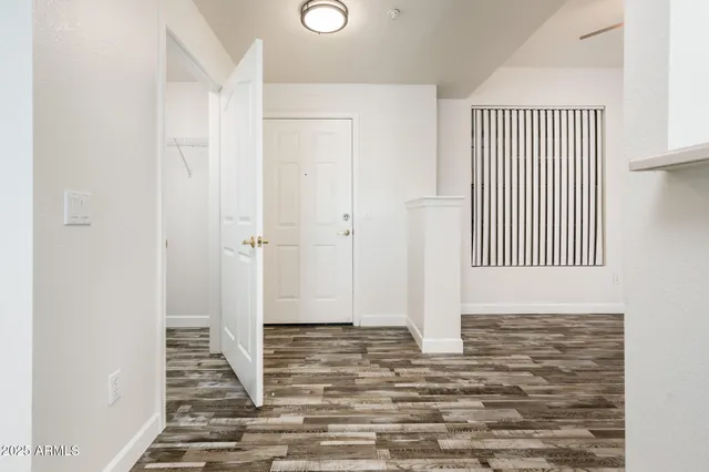 a view of a hallway with wooden floor and staircase