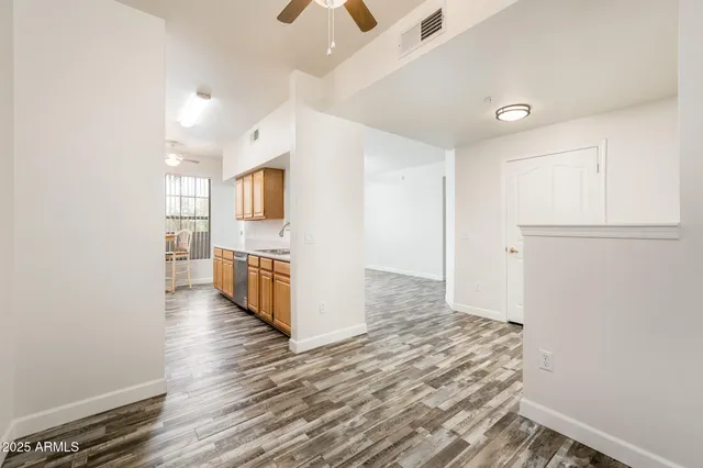 a view of a kitchen with wooden floor and a refrigerator