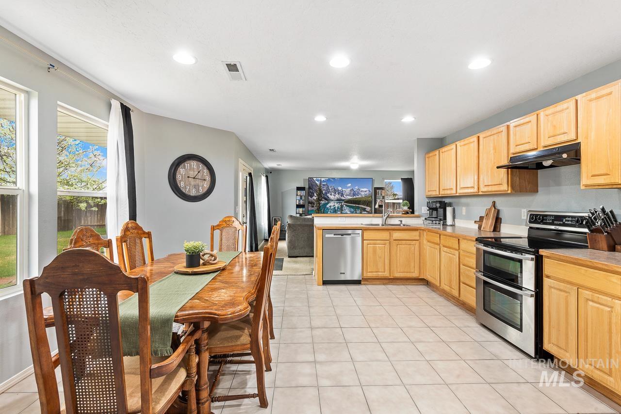 16290 Jewel Way Caldwell, ID 83607 - Photo 12 of 36 Kitchen with light wood finish cabinets, stainless steel appliances, healthy amount of natural light, light tile patterned floors, and recessed lighting