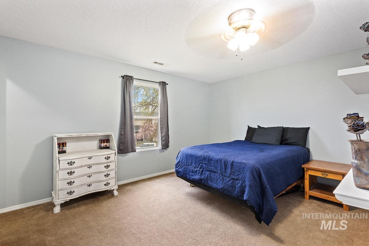 16290 Jewel Way Caldwell, ID 83607 - Photo 23 of 36 Carpeted bedroom with ceiling fan and a textured ceiling