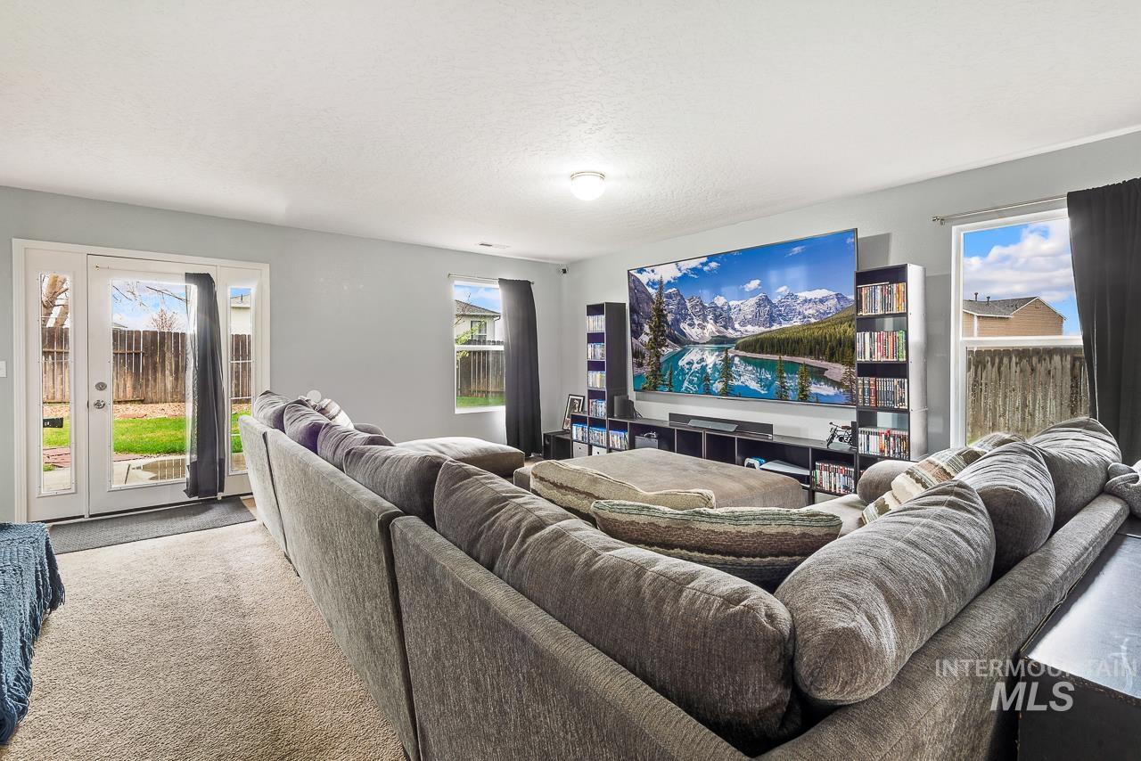 16290 Jewel Way Caldwell, ID 83607 - Photo 6 of 36 Carpeted living room with plenty of natural light and a textured ceiling