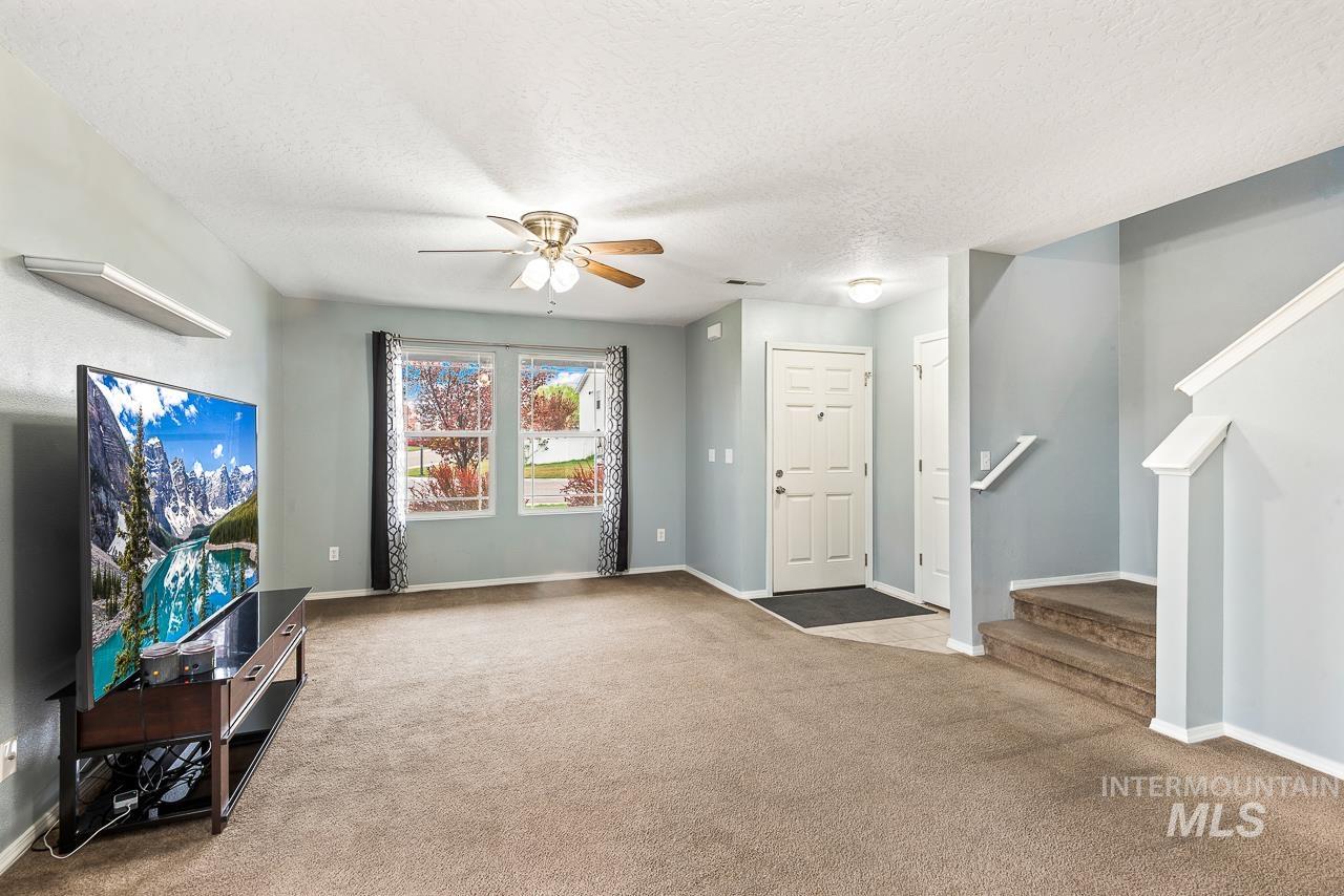 16290 Jewel Way Caldwell, ID 83607 - Photo 9 of 36 Entrance foyer featuring ceiling fan, a textured ceiling, and carpet