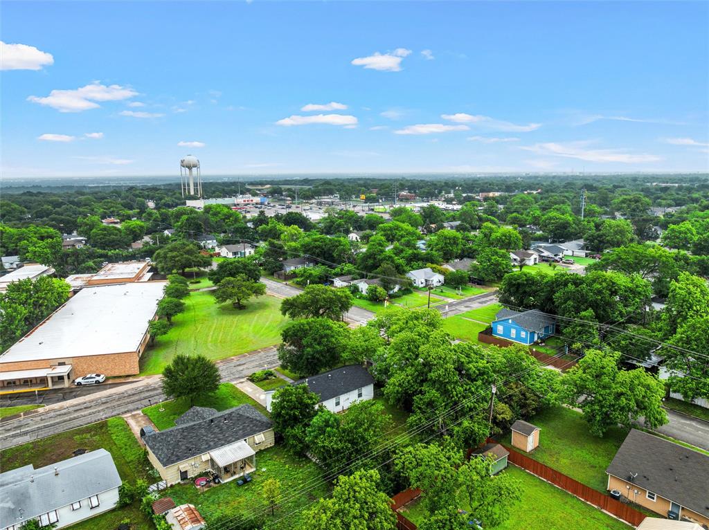 3904 North 21st A Street Waco, TX 76708 - Photo 23 of 26 Aerial view of a residential area with mature trees and a distant water tower